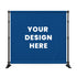 A blue customizable backdrop banner mounted on a black metal stand, featuring the white text 'YOUR DESIGN HERE' in the center, set against a plain white background.