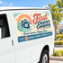 A white van with a large retro-style 'First Cleaners Company' logo decal on the side door, shown outdoors on a sunny day with trees and a building in the background.