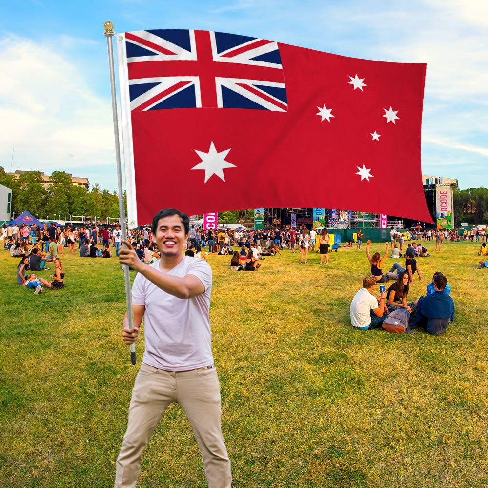 Man holding Australia Ensign  Printed Polyester Flag 3ft by 5ft on 6ft Hand Held Pole at Parade