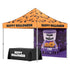 Halloween-themed pop-up canopy tent with an orange top, black bat pattern, and 'HAPPY HALLOWEEN' text, shown with a matching black tablecloth featuring white 'HAPPY HALLOWEEN' lettering. The canopy also includes a purple printed back panel with a trick-or-treat truck and bats.