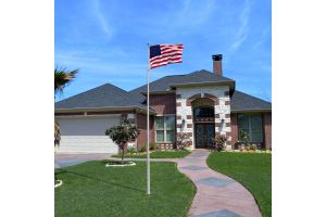 16ft Aluminum Residential Pole with Ball Top Displaying USA Flag Outside Home