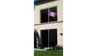 20ft Aluminum Residential Pole with Eagle Top Displaying USA Flag Outside business